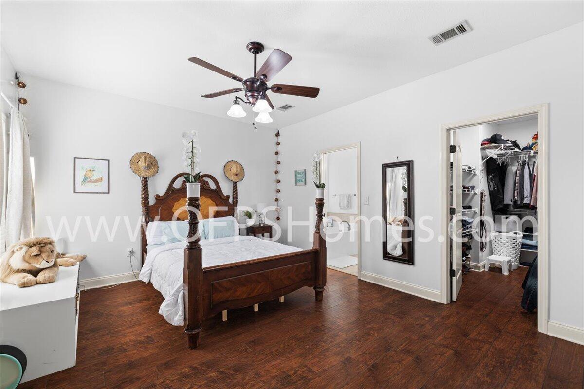 4632 Hermosa Road Crestview, FL 32539 - Photo 14 of 35 a room with a bed and a chandelier