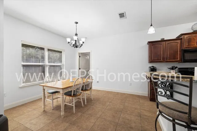 a view of a dining room with furniture window and outside view