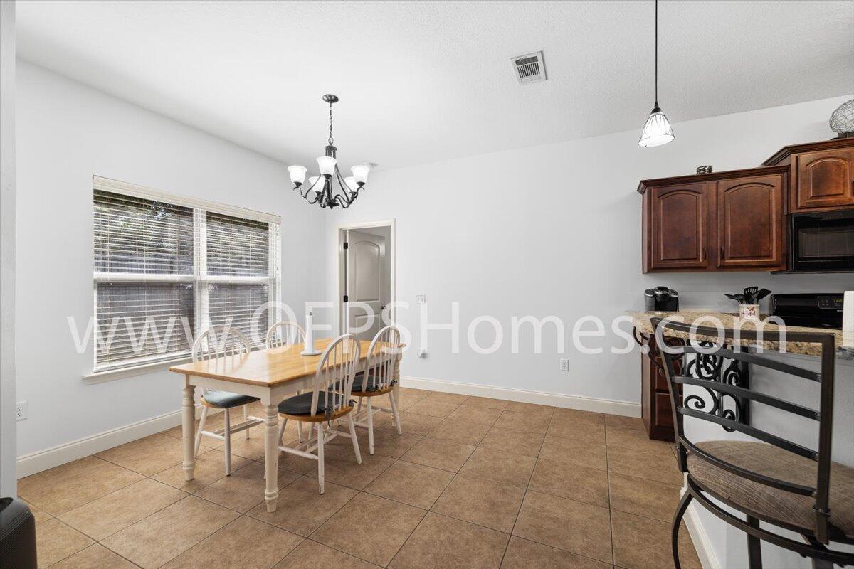 4632 Hermosa Road Crestview, FL 32539 - Photo 15 of 35 a view of a dining room with furniture window and outside view