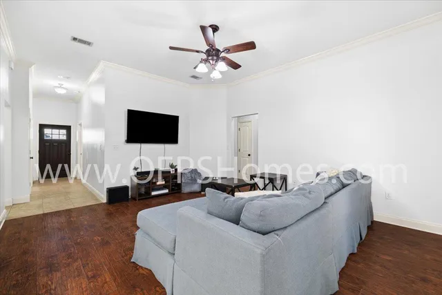 a living room with furniture and a flat screen tv