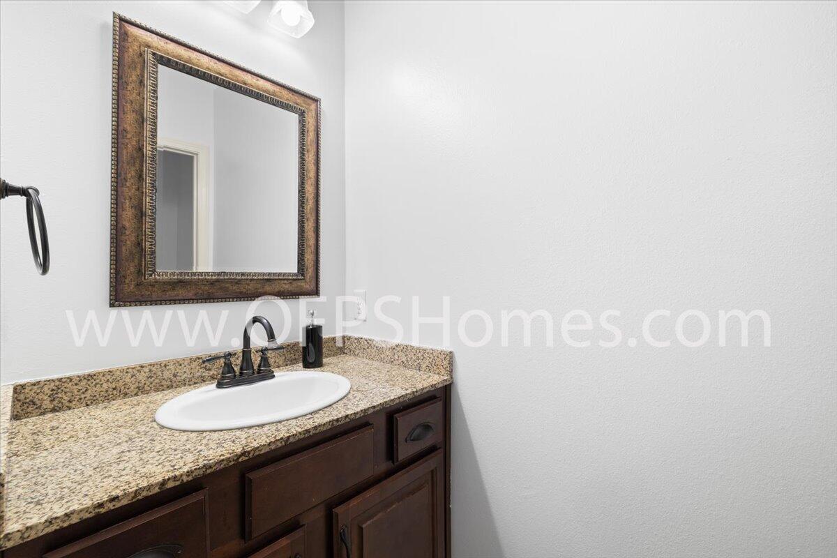 4632 Hermosa Road Crestview, FL 32539 - Photo 26 of 35 a bathroom with a granite countertop sink and a mirror