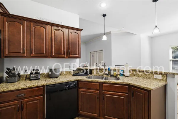 a kitchen with sink a oven a counter space and cabinets