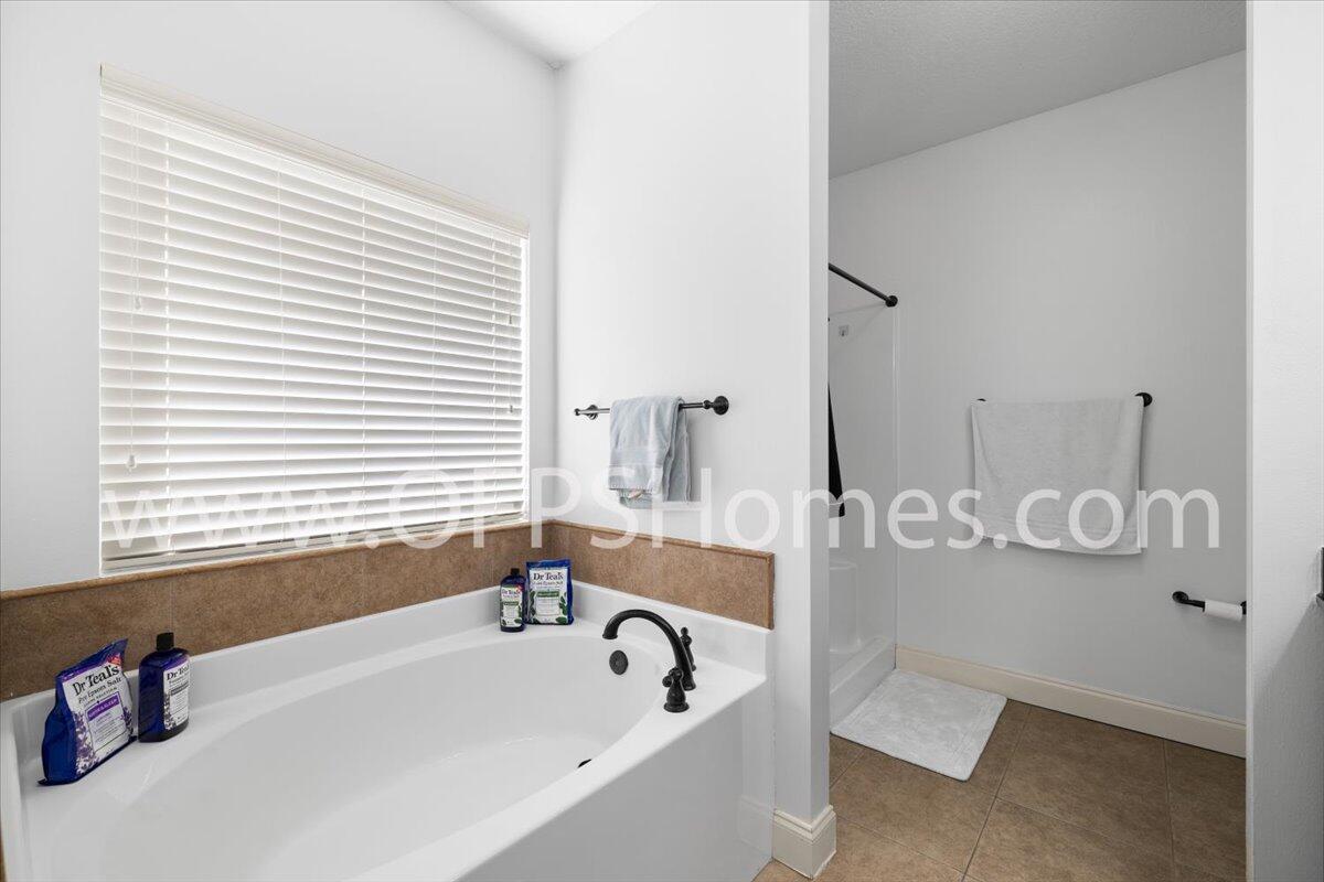4632 Hermosa Road Crestview, FL 32539 - Photo 10 of 35 a bathroom with a tub sink and mirror