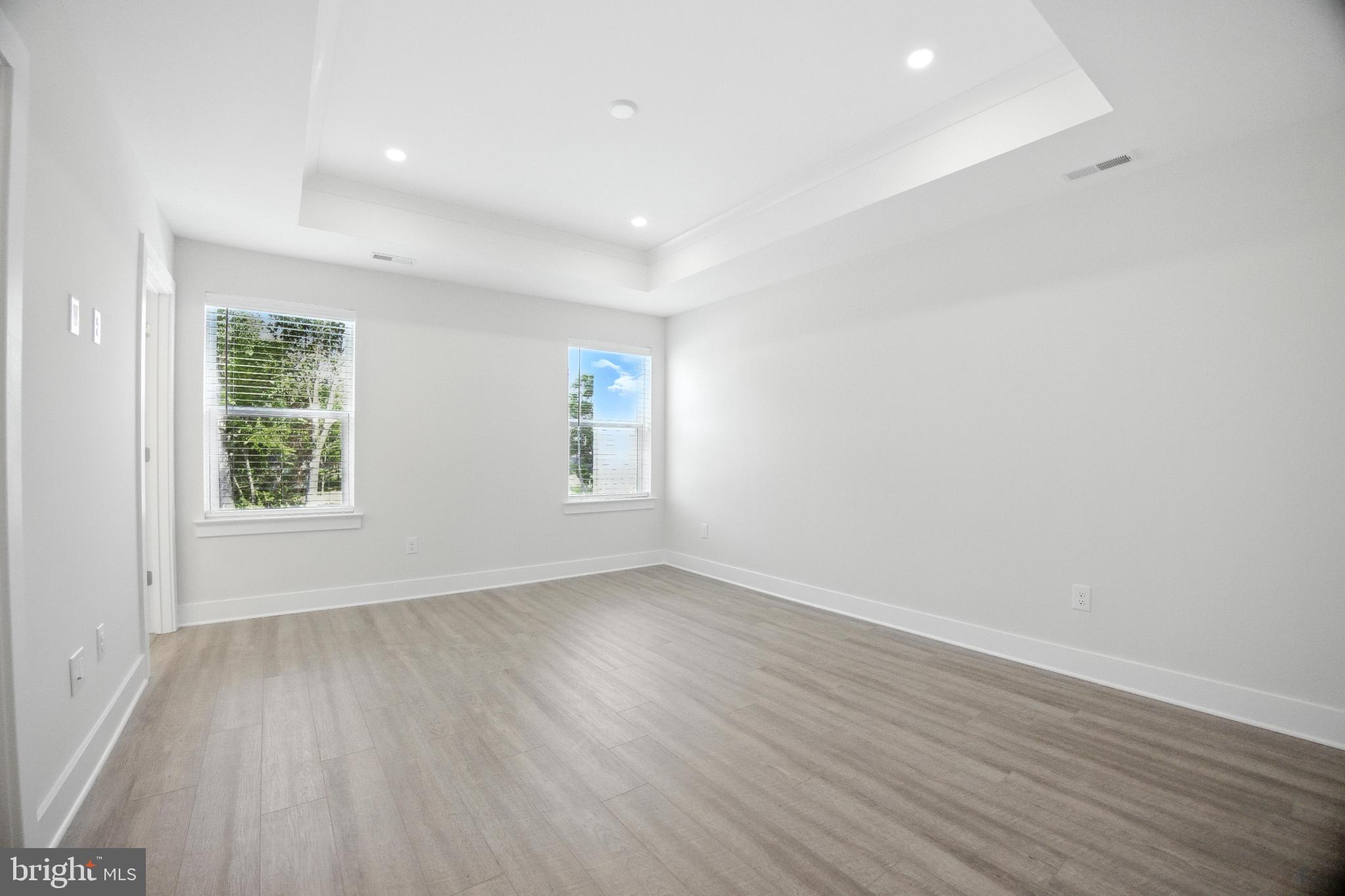 43 Sequoia Drive Berlin, NJ 08009 - Photo 11 of 40 an empty room with wooden floor and windows
