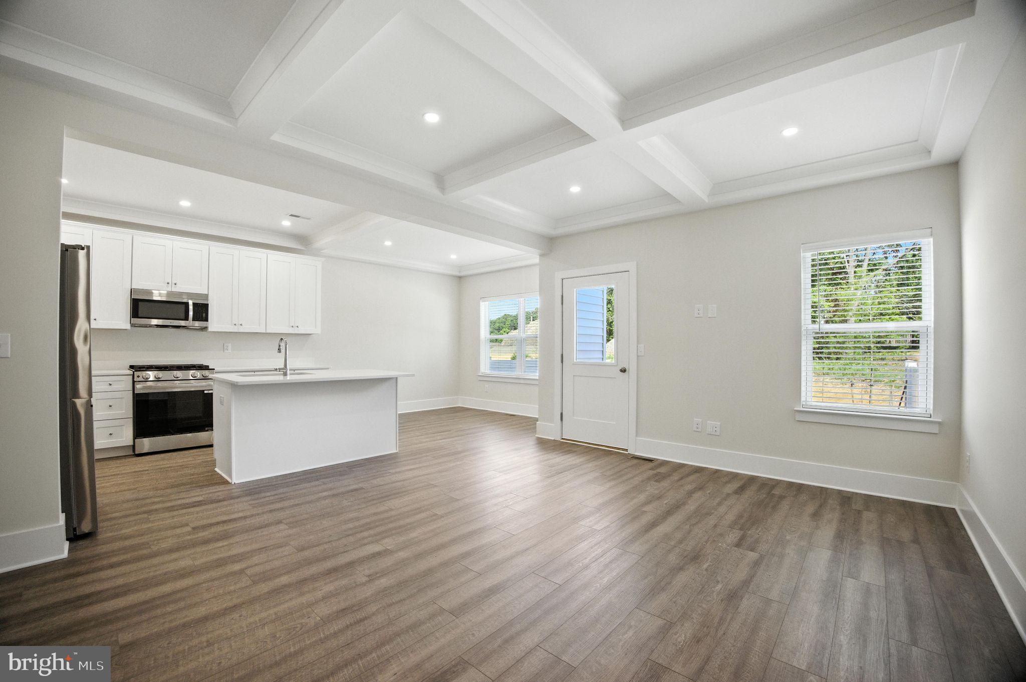43 Sequoia Drive Berlin, NJ 08009 - Photo 12 of 40 a large kitchen with stainless steel appliances granite countertop a large center island a stove a sink dishwasher and a refrigerator with wooden floor