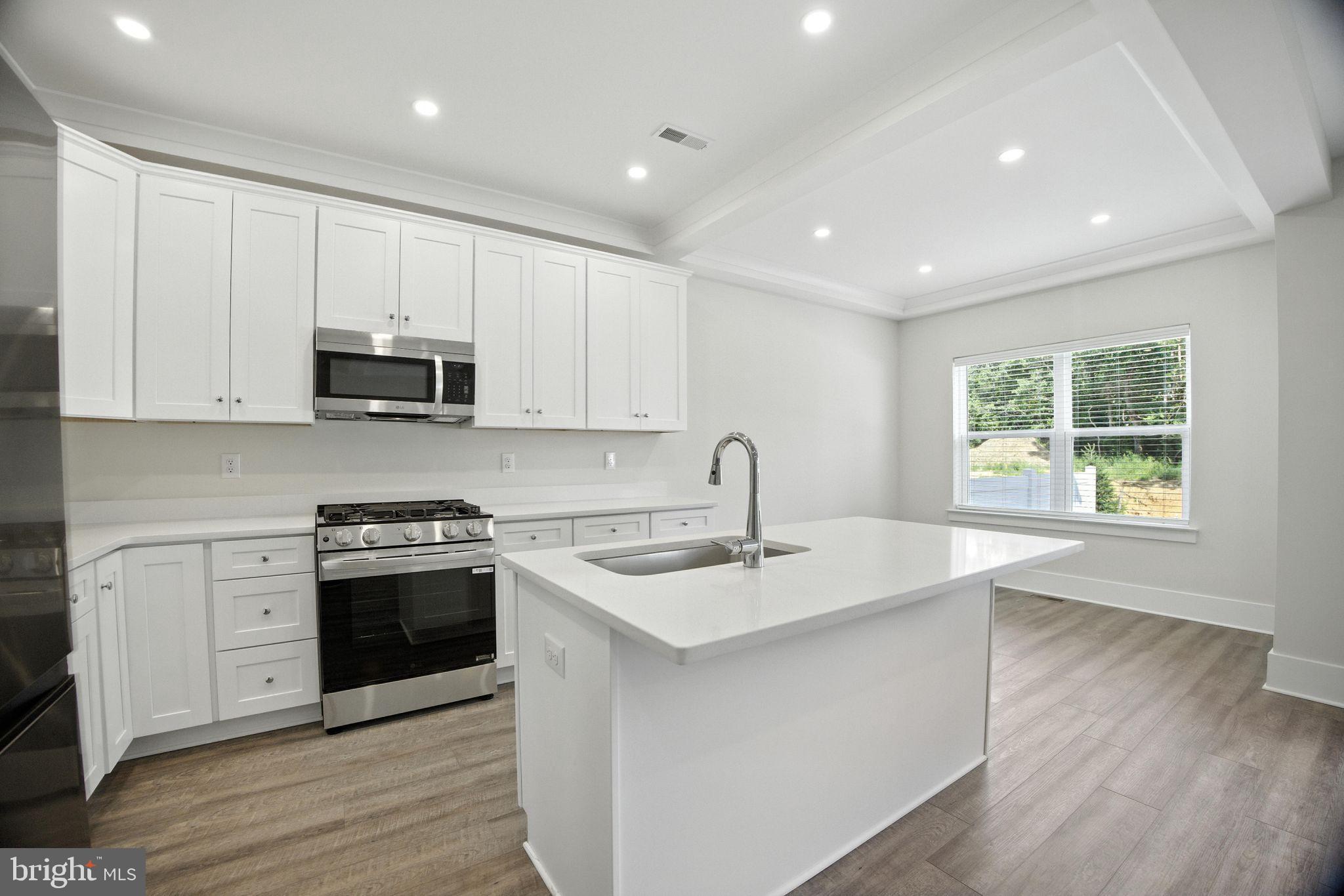 43 Sequoia Drive Berlin, NJ 08009 - Photo 13 of 40 a kitchen with stainless steel appliances granite countertop a sink a stove and a wooden floors