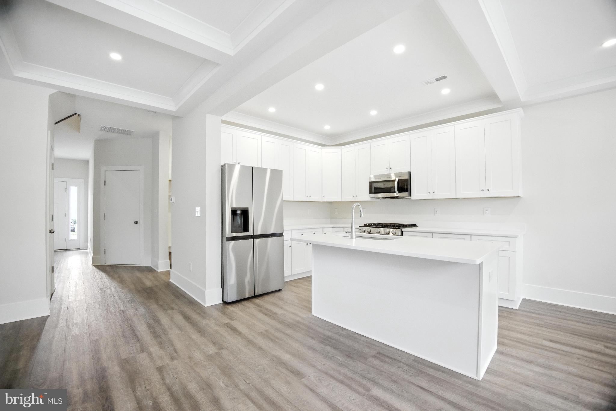43 Sequoia Drive Berlin, NJ 08009 - Photo 16 of 40 a kitchen with a refrigerator a stove top oven and wooden floor