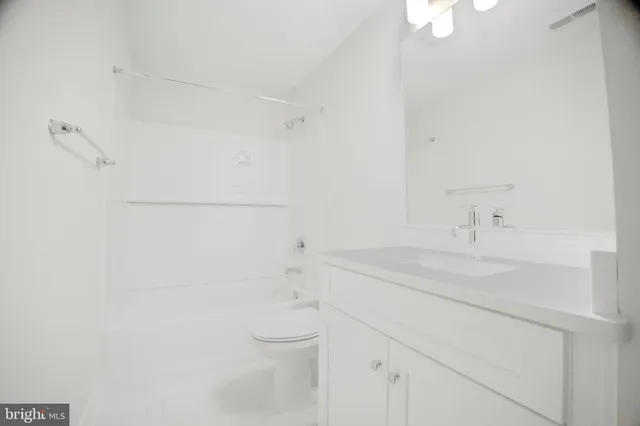 a bathroom with a sink toilet and vanity