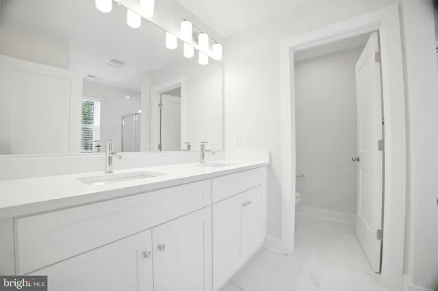 a bathroom with 2 sink and a mirror