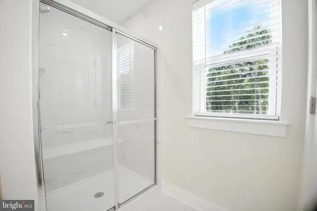 a bathroom with a glass shower door