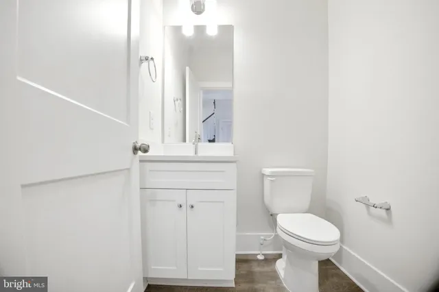 a bathroom with a toilet a sink and mirror