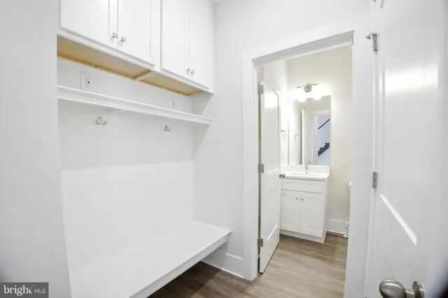 a room with a walk in closet and wooden floor