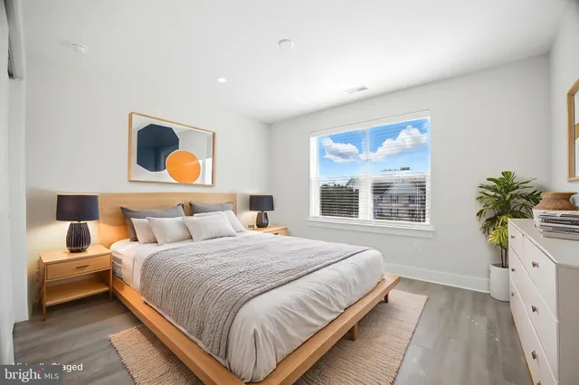 a bedroom with a bed and a potted plant