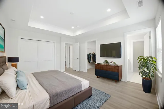 a bedroom with a large bed and a flat screen tv