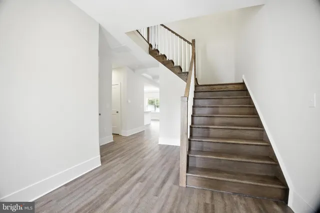a view of entryway and hall with wooden floor