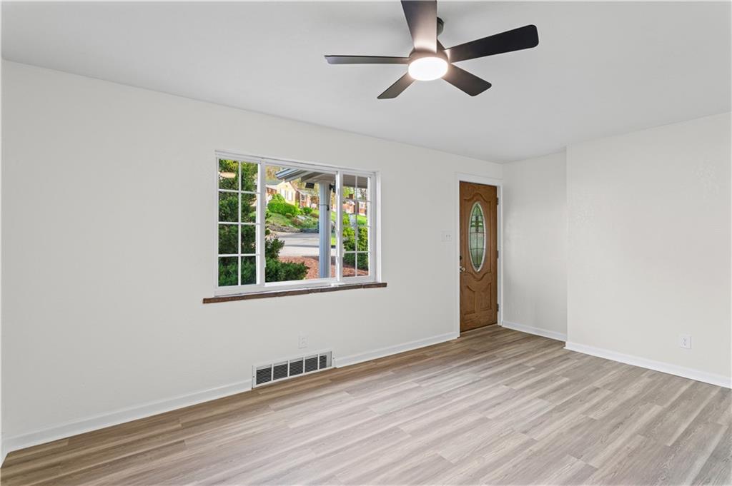 1305 Main Street Bridgeville, PA 15017 - Photo 13 of 50 wooden floor in an empty room with a window