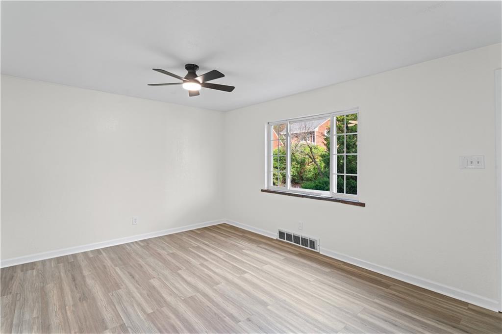 1305 Main Street Bridgeville, PA 15017 - Photo 14 of 50 wooden floor in an empty room with a window