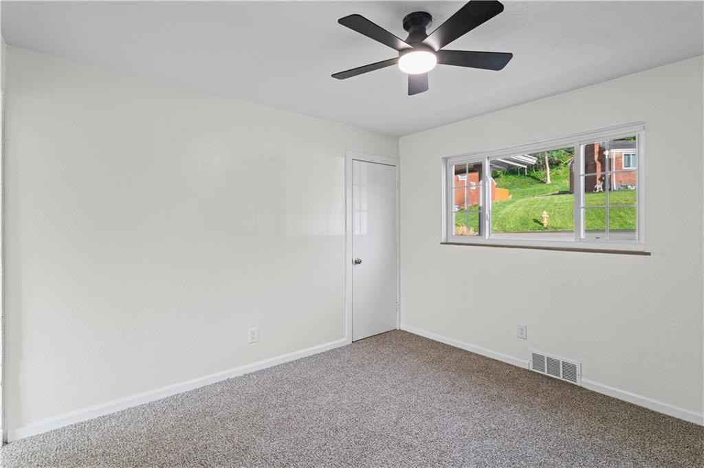 1305 Main Street Bridgeville, PA 15017 - Photo 24 of 50 an empty room with window and ceiling fan