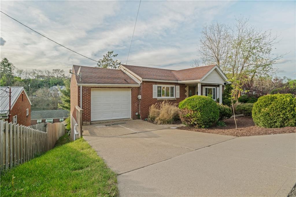 1305 Main Street Bridgeville, PA 15017 - Photo 3 of 50 a front view of a house with a garden