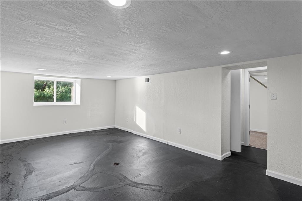 1305 Main Street Bridgeville, PA 15017 - Photo 32 of 50 an empty room with wooden floor and windows
