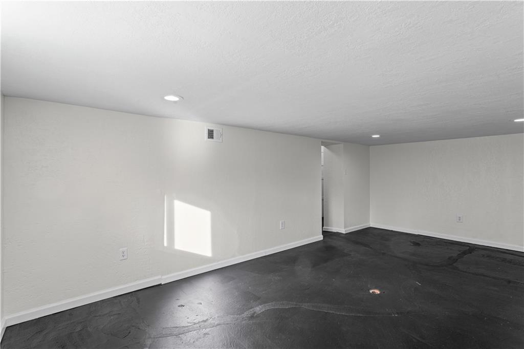 1305 Main Street Bridgeville, PA 15017 - Photo 34 of 50 an empty room with wooden floor and windows