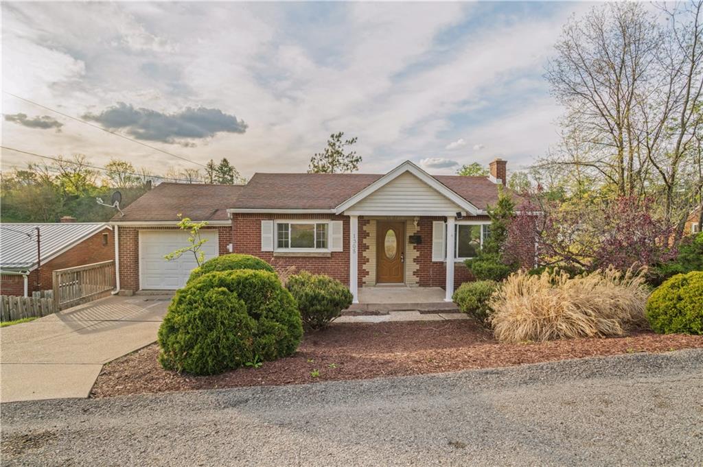 1305 Main Street Bridgeville, PA 15017 - Photo 49 of 50 a front view of a house with a garden