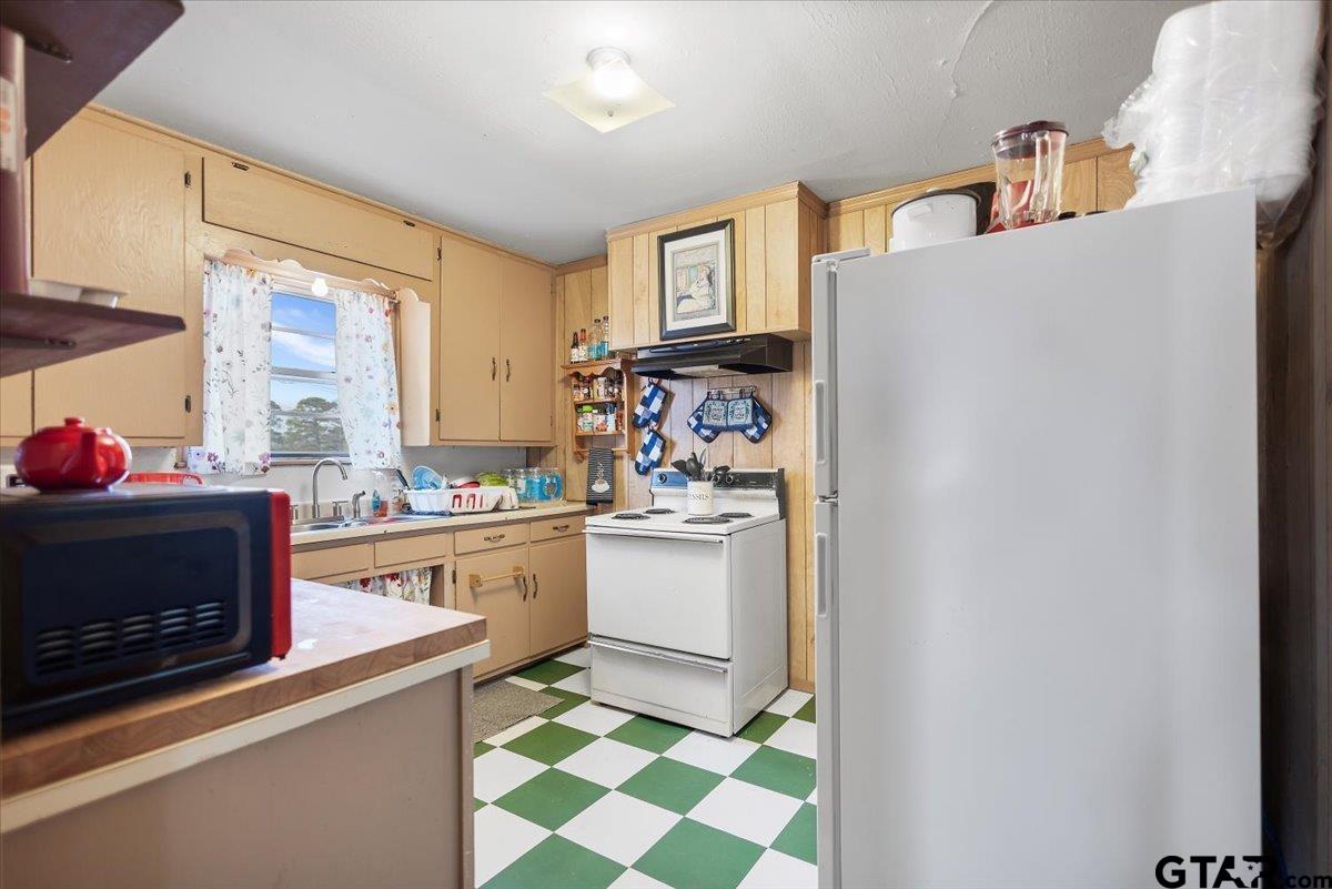 1706 Baxter Avenue Longview, TX 75602 - Photo 5 of 32 a kitchen with stainless steel appliances a stove and a refrigerator