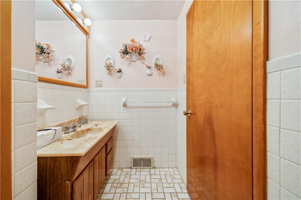 361 Maple Road Pittsburgh, PA 15239 - Photo 20 of 38 a bathroom with a sink and a mirror