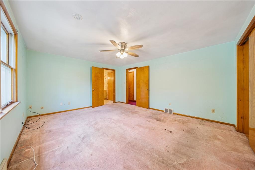 361 Maple Road Pittsburgh, PA 15239 - Photo 23 of 38 an empty room with windows and ceiling fan