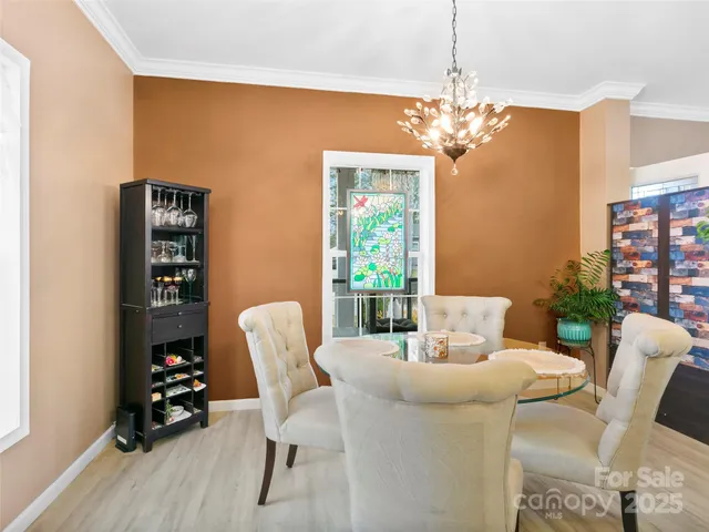 a dining room with furniture and chandelier