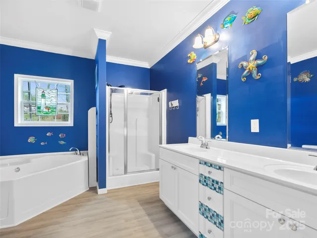 a bathroom with a sink a bathtub and a large mirror