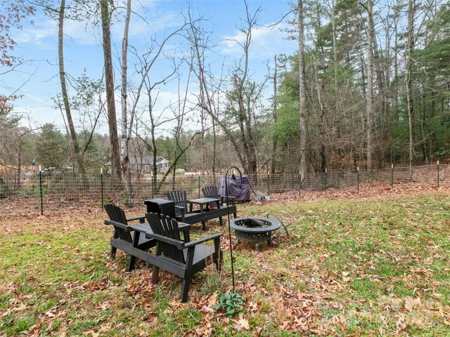 a backyard of a house with table and chairs