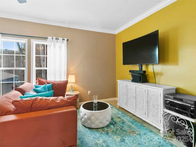 a living room with furniture and a flat screen tv