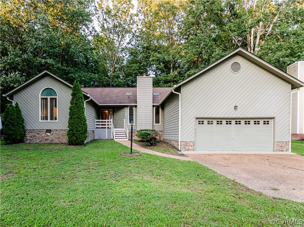 a view of a house with a yard and garage