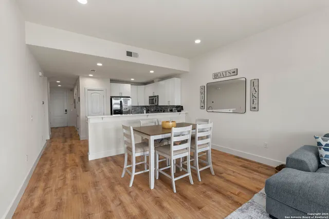 a dining room with furniture and wooden floor