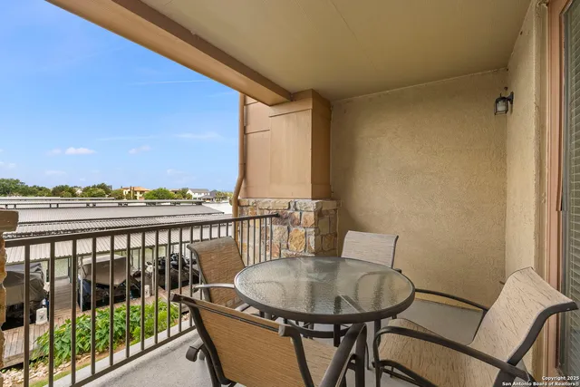 a view of a chair and tables in the balcony