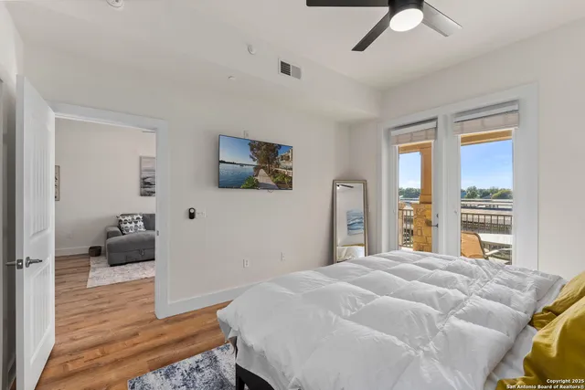 a bedroom with a bed and a large window