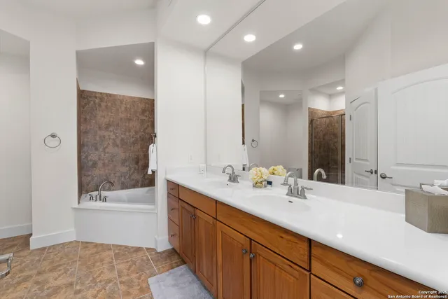 a bathroom with a sink a bathtub and a mirror