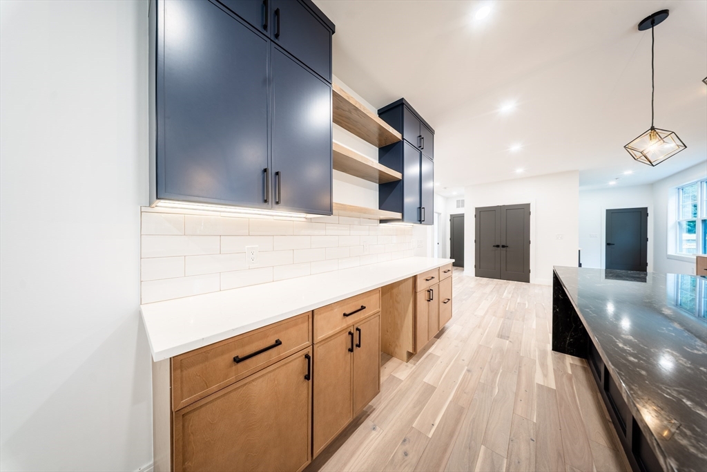 2 Spring Meadow Drive Southborough, MA 01772 - Photo 11 of 42 a view of a kitchen with kitchen island white cabinets and stainless steel appliances