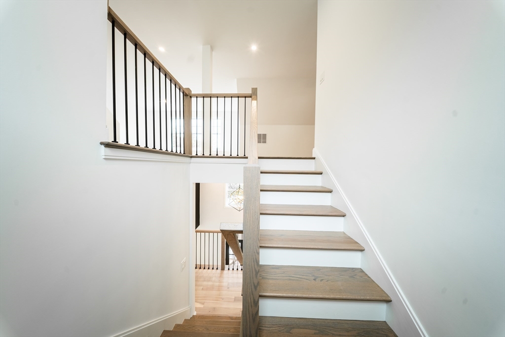 2 Spring Meadow Drive Southborough, MA 01772 - Photo 33 of 42 a view of staircase with lots of frames on wall and white walls