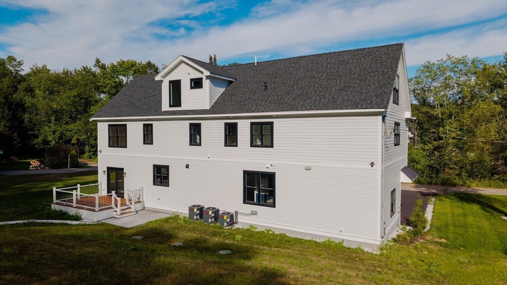 2 Spring Meadow Drive Southborough, MA 01772 - Photo 39 of 42 a big house with a big yard and more windows