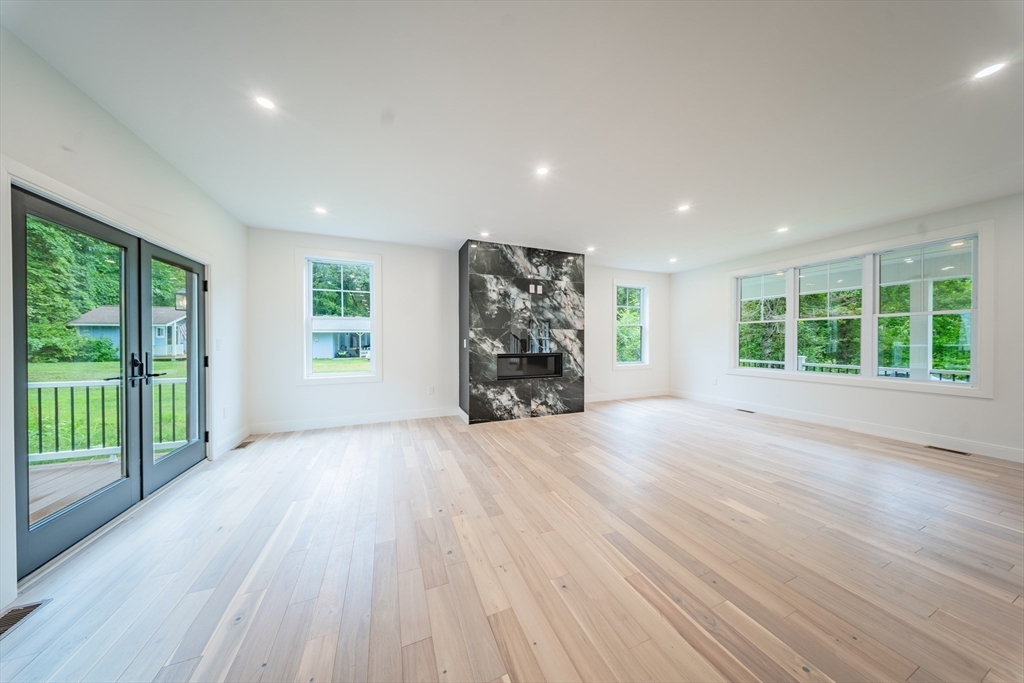 2 Spring Meadow Drive Southborough, MA 01772 - Photo 8 of 42 a view of an empty room with a window and wooden floor