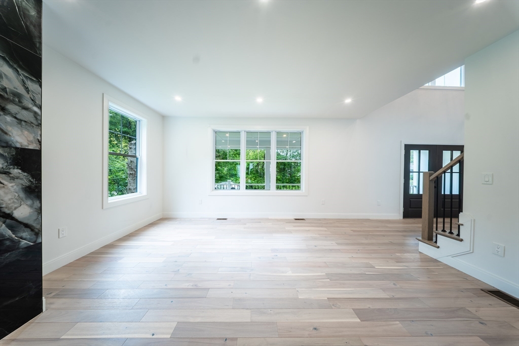 2 Spring Meadow Drive Southborough, MA 01772 - Photo 9 of 42 a view of an empty room with wooden floor and a window