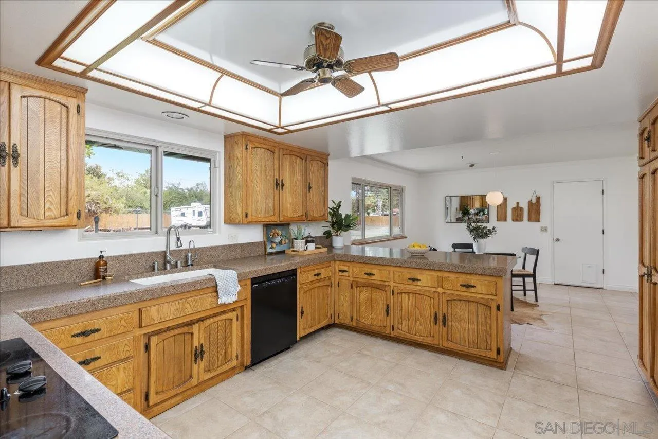 1786 Lorry Lane Escondido, CA 92029 - Photo 14 of 39 a kitchen with stainless steel appliances granite countertop a sink and cabinets
