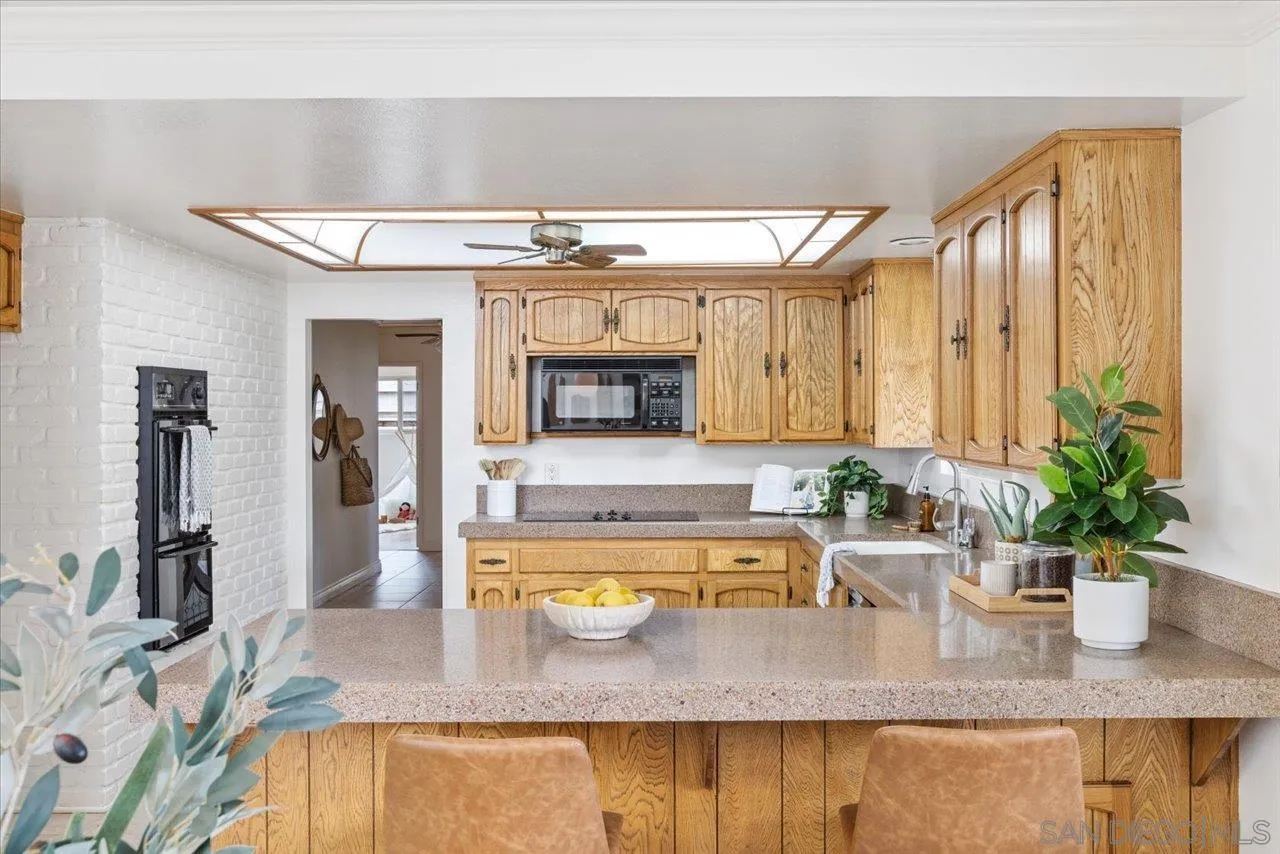 1786 Lorry Lane Escondido, CA 92029 - Photo 16 of 39 a bathroom with a granite countertop sink and a large mirror