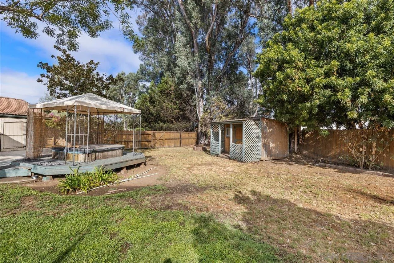 1786 Lorry Lane Escondido, CA 92029 - Photo 22 of 39 a backyard of a house with table and chairs under an umbrella