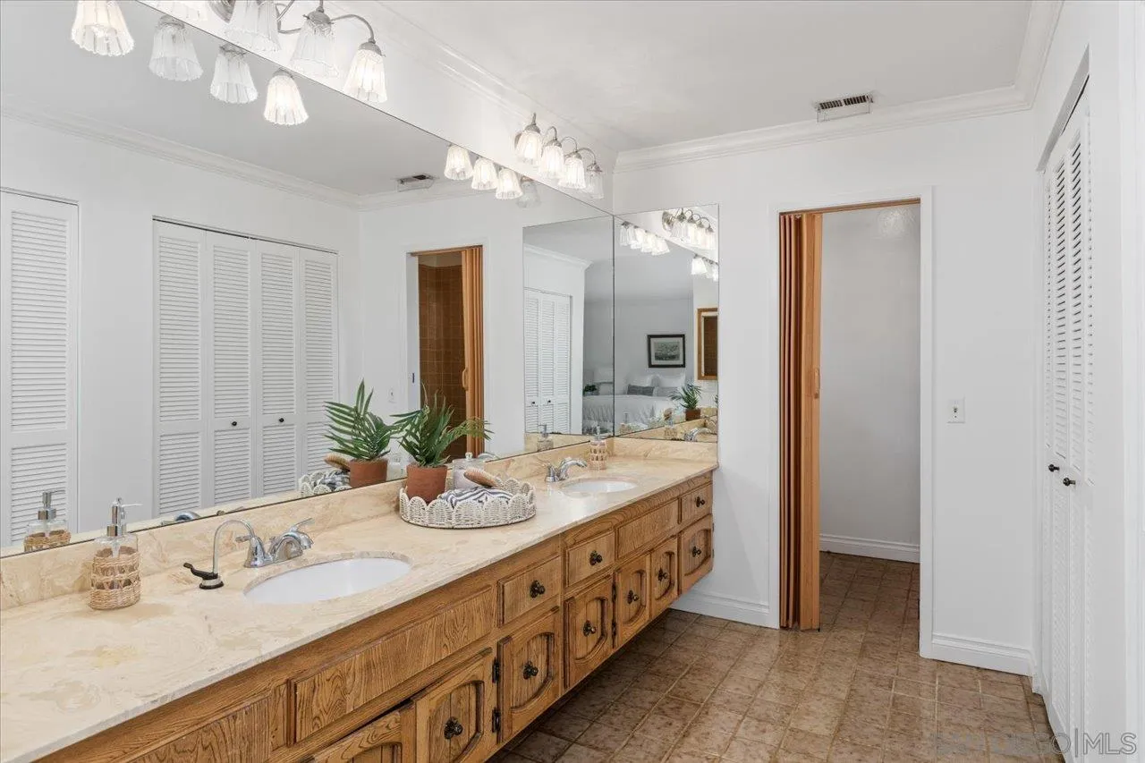 1786 Lorry Lane Escondido, CA 92029 - Photo 29 of 39 a bathroom with a double vanity sink and a mirror