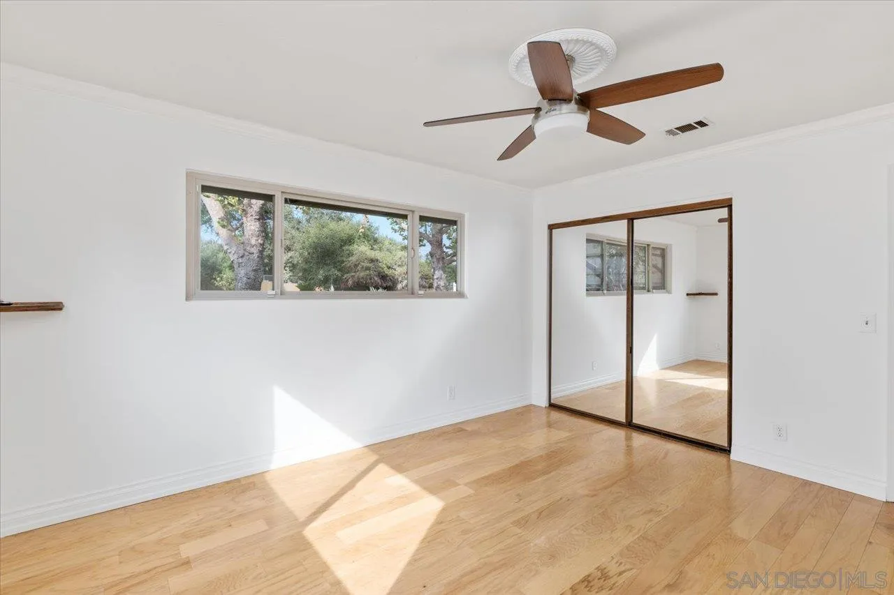 1786 Lorry Lane Escondido, CA 92029 - Photo 32 of 39 a view of empty room with wooden floor and fan