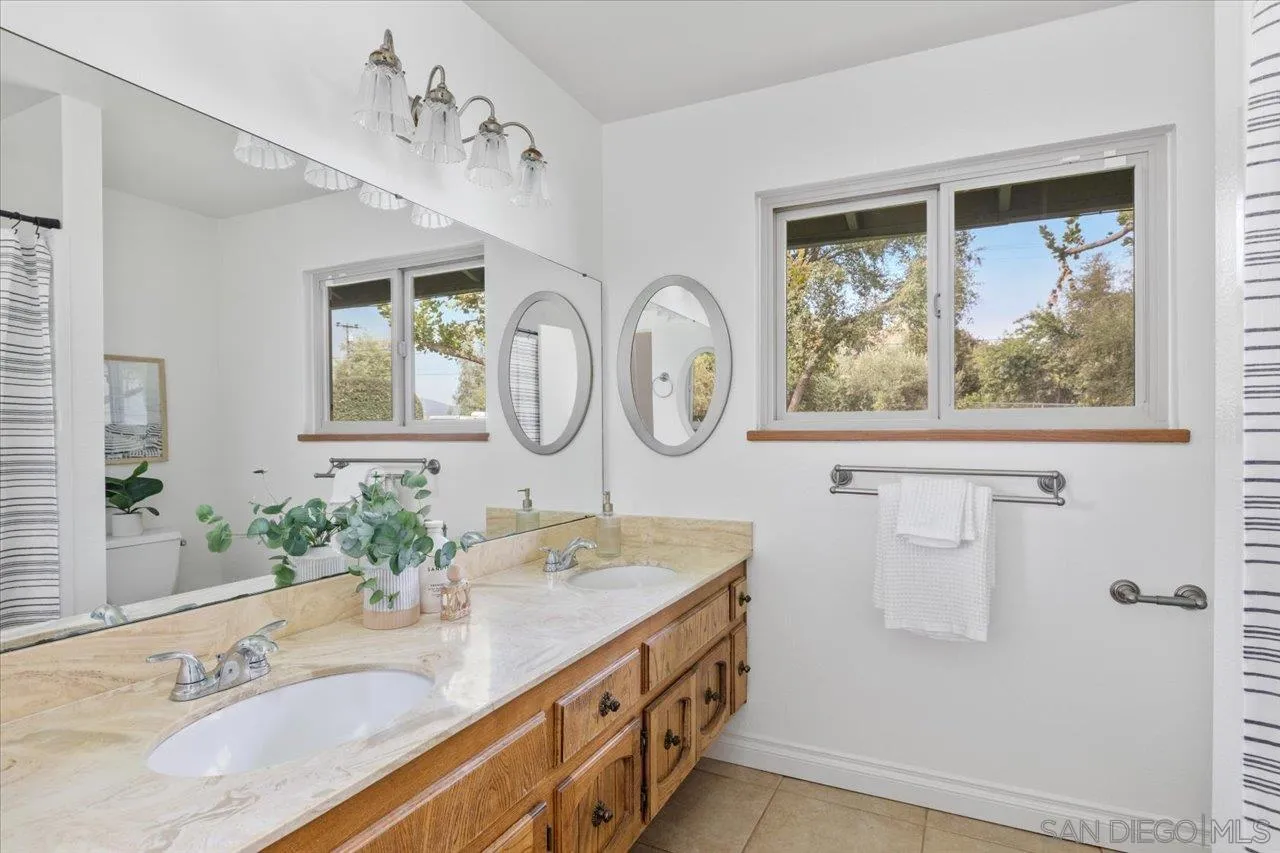 1786 Lorry Lane Escondido, CA 92029 - Photo 33 of 39 a bathroom with a granite countertop double vanity sink and a mirror
