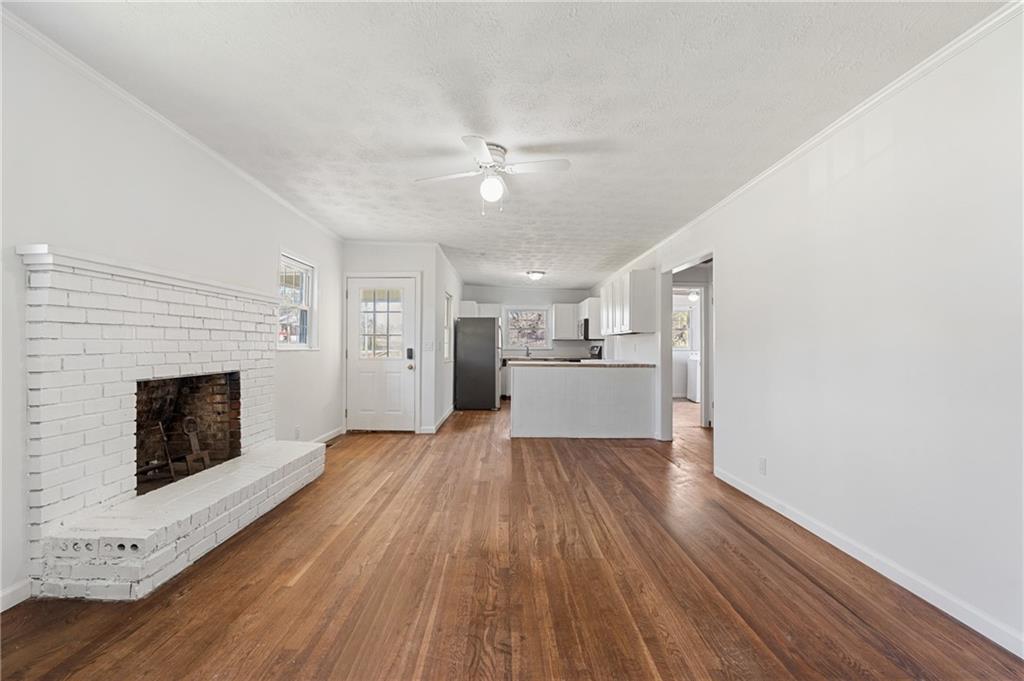 173 Winndale Road Dallas, GA 30157 - Photo 2 of 23 a view of a kitchen with wooden floor and a fireplace